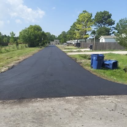 Long private drive built with a crown so water sheds to the sides.