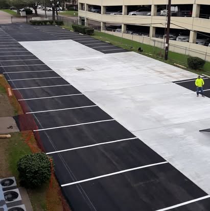 Parking lot paved and striped end to end.