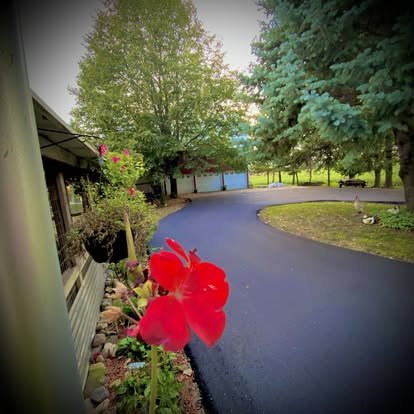 Curved residential drive tied into the existing carport.